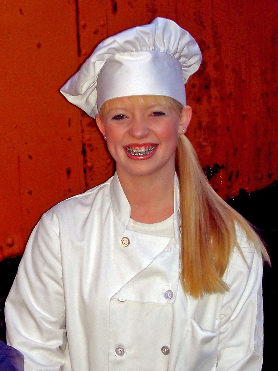 Chef wearing apron and gloves preparing food